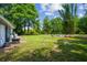 Large, grassy backyard with ample space, leading to a fire pit area for outdoor enjoyment at 10301 Nina Ct, New Port Richey, FL 34654