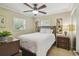 Cozy bedroom with carpet flooring, neutral wall paint, a large bed, and natural lighting at 10301 Nina Ct, New Port Richey, FL 34654