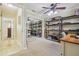 Cozy bedroom with mirrored closet, ceiling fan, and built in shelving for storage solutions at 10301 Nina Ct, New Port Richey, FL 34654