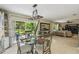 Bright dining area with glass table and chairs, large sliding doors with view of lush green backyard at 10301 Nina Ct, New Port Richey, FL 34654