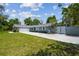 Charming single-story home featuring a large front yard, long driveway, and decorative privacy gate at 10301 Nina Ct, New Port Richey, FL 34654
