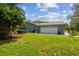 Charming single-story home featuring a two-car garage, hot tub, and a well-manicured lawn at 10301 Nina Ct, New Port Richey, FL 34654