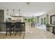 Kitchen with bar seating, stainless steel appliances, and adjacent dining area at 10301 Nina Ct, New Port Richey, FL 34654