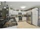 Modern kitchen with stainless steel appliances, marble countertops, and ample cabinet space at 10301 Nina Ct, New Port Richey, FL 34654
