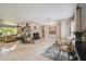 Bright living room with stone fireplace, tile floors, and comfortable seating arrangement at 10301 Nina Ct, New Port Richey, FL 34654