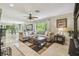 Open living room with neutral furniture, tile flooring, and lots of natural light at 10301 Nina Ct, New Port Richey, FL 34654