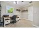Bright home office with neutral decor, carpet floors, and a window offering natural light for a comfortable workspace at 10301 Nina Ct, New Port Richey, FL 34654