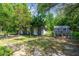 Backyard shed and chicken coop offering versatile space for hobbies, storage, and farm fresh eggs at 10301 Nina Ct, New Port Richey, FL 34654