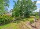 Lush backyard with mature trees, green grass, landscaping, and plenty of space at 10442 Ventura Dr, Spring Hill, FL 34608