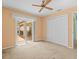 Bright bedroom featuring a ceiling fan, sliding glass doors, and a double-door closet at 10442 Ventura Dr, Spring Hill, FL 34608