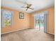 Bedroom with natural light, a ceiling fan, and sliding doors that offer a view of the outdoor pool at 10442 Ventura Dr, Spring Hill, FL 34608