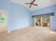 A spacious bedroom with a ceiling fan and sliding glass doors leading to the patio at 10442 Ventura Dr, Spring Hill, FL 34608