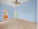 A bedroom featuring a ceiling fan and an adjoining bathroom with a vanity at 10442 Ventura Dr, Spring Hill, FL 34608