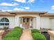 Close-up of the home's inviting front entrance with a meticulously maintained garden and water feature at 10442 Ventura Dr, Spring Hill, FL 34608