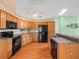 Well-lit kitchen featuring wooden cabinets, black appliances, and a skylight above at 10442 Ventura Dr, Spring Hill, FL 34608