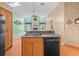 Kitchen island with stainless steel sink and dishwasher offering views of the Gathering room at 10442 Ventura Dr, Spring Hill, FL 34608