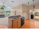Kitchen island with sink and dishwasher offering seamless transition to the Gathering room at 10442 Ventura Dr, Spring Hill, FL 34608