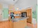 Bright kitchen features wood cabinets, black appliances, and breakfast bar area at 10442 Ventura Dr, Spring Hill, FL 34608
