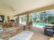 Spacious screened lanai with outdoor seating and views of the pool and backyard at 10442 Ventura Dr, Spring Hill, FL 34608