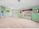 Expansive living room bathed in natural light, plush carpeting, and open entry offering versatile layout options at 10442 Ventura Dr, Spring Hill, FL 34608