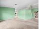 Expansive living room showcasing wall-to-wall carpeting, neutral colors, and a seamlessly flowing layout at 10442 Ventura Dr, Spring Hill, FL 34608