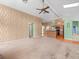 Spacious living room with kitchen access and a unique wall texture and design at 10442 Ventura Dr, Spring Hill, FL 34608