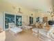 Covered patio featuring wicker furniture, ceiling fan and sliding glass doors leading to the backyard at 10442 Ventura Dr, Spring Hill, FL 34608
