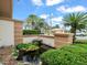 Close up of the property's beautifully landscaped entrance featuring a tranquil pond and lush greenery at 10442 Ventura Dr, Spring Hill, FL 34608