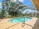 Inviting screened-in pool area perfect for relaxation and outdoor entertainment in a backyard at 10442 Ventura Dr, Spring Hill, FL 34608