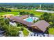 Aerial view of the YMCA featuring a pool, baseball field, parking and surrounding landscape at 1049 Larkin Rd, Spring Hill, FL 34608