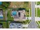 Overhead view of a home with a screened pool and a well-manicured backyard and landscaping at 1049 Larkin Rd, Spring Hill, FL 34608