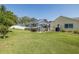 Spacious backyard featuring a screened-in pool area, perfect for outdoor entertaining at 1049 Larkin Rd, Spring Hill, FL 34608