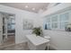Bright bathroom with soaking tub, plantation shutters, and access to main bedroom at 1049 Larkin Rd, Spring Hill, FL 34608