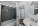 Bathroom with a glass-enclosed shower, basin sink, and tiled floors at 1049 Larkin Rd, Spring Hill, FL 34608