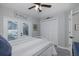 Bedroom featuring carpeted floors, a ceiling fan and access to a private screened-in lanai and pool at 1049 Larkin Rd, Spring Hill, FL 34608