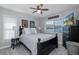 Cozy bedroom with a ceiling fan, gray walls, and dark furnishings at 1049 Larkin Rd, Spring Hill, FL 34608
