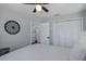 Relaxing bedroom with a ceiling fan, white linens, and ample closet space at 1049 Larkin Rd, Spring Hill, FL 34608