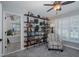 Bedroom with built-in shelving, ceiling fan, and plantation shutters at 1049 Larkin Rd, Spring Hill, FL 34608