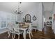 Sunlit dining room featuring plantation shutters, hardwood floors, and elegant decor at 1049 Larkin Rd, Spring Hill, FL 34608