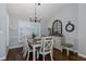 Sunlit dining room featuring plantation shutters, hardwood floors, and elegant decor at 1049 Larkin Rd, Spring Hill, FL 34608