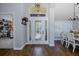 Welcoming entryway with decorative front door, hardwood floors, and an open floor plan at 1049 Larkin Rd, Spring Hill, FL 34608