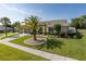 Beautiful one-story home with a well-maintained lawn, complemented by a palm tree and a two-car garage at 1049 Larkin Rd, Spring Hill, FL 34608