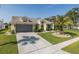 Inviting one-story home with a manicured lawn, mature landscaping, and a convenient two-car garage at 1049 Larkin Rd, Spring Hill, FL 34608