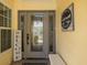 Front door and sidelights, with welcome sign and home decor at 1049 Larkin Rd, Spring Hill, FL 34608