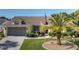 Charming home with a well-manicured front yard, beautiful landscaping, and an American flag at 1049 Larkin Rd, Spring Hill, FL 34608