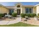 Charming home featuring manicured landscaping, a walkway, and a decorative fountain at 1049 Larkin Rd, Spring Hill, FL 34608
