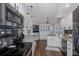 Bright, upgraded kitchen with granite counters, black appliances, and modern lighting fixtures at 1049 Larkin Rd, Spring Hill, FL 34608
