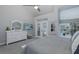 Bright main bedroom with French doors to pool, ceiling fan, and neutral colors at 1049 Larkin Rd, Spring Hill, FL 34608