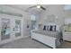 Serene bedroom with French doors to the pool, neutral tones, and natural light at 1049 Larkin Rd, Spring Hill, FL 34608