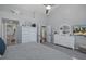 Bright main bedroom with white furnishings, ceiling fan, and ensuite bathroom access at 1049 Larkin Rd, Spring Hill, FL 34608
